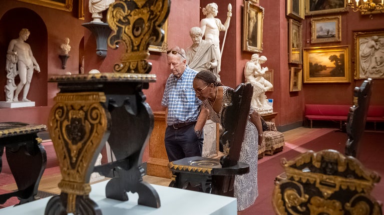 Visitors exploring the 125 Treasures exhibition at Petworth House and Park, West Sussex